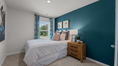 secondary bedroom featuring carpet and window