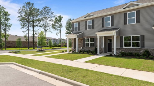 front exterior of townhome featuring light tan patio set