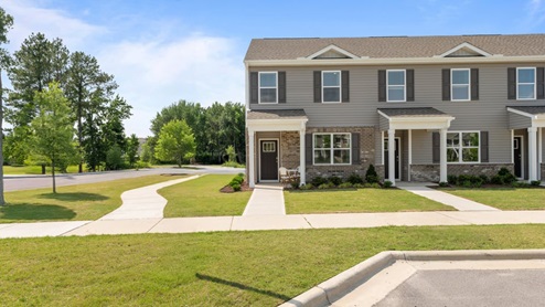 front exterior of townhome featuring light tan patio set