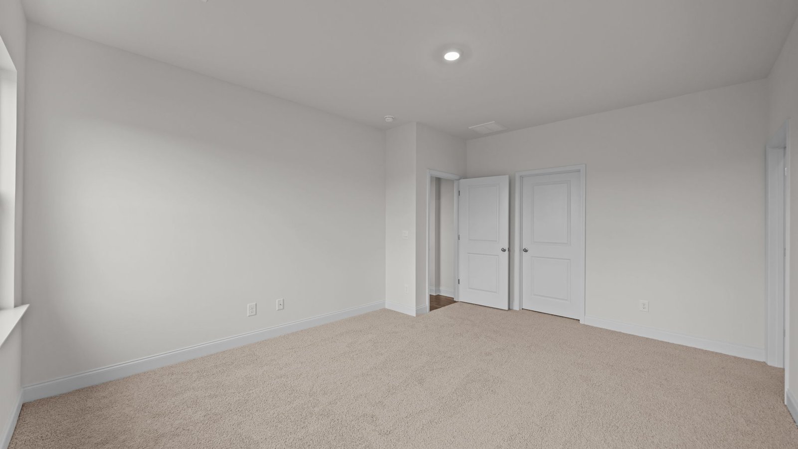 carpeted primary bedroom