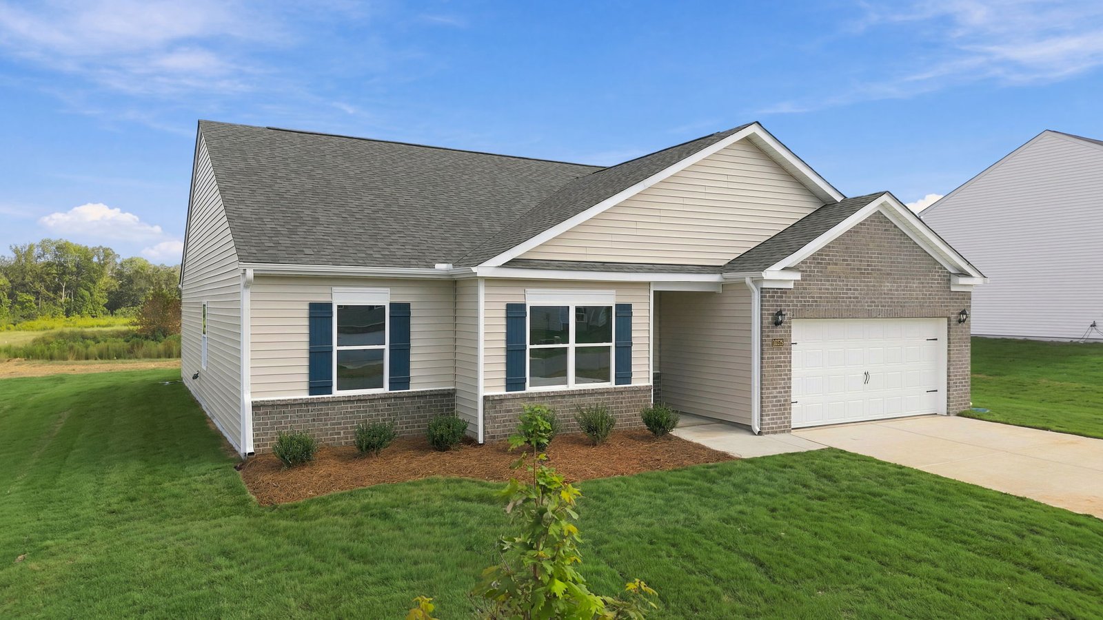 front view of single story family home with front yard and driveway