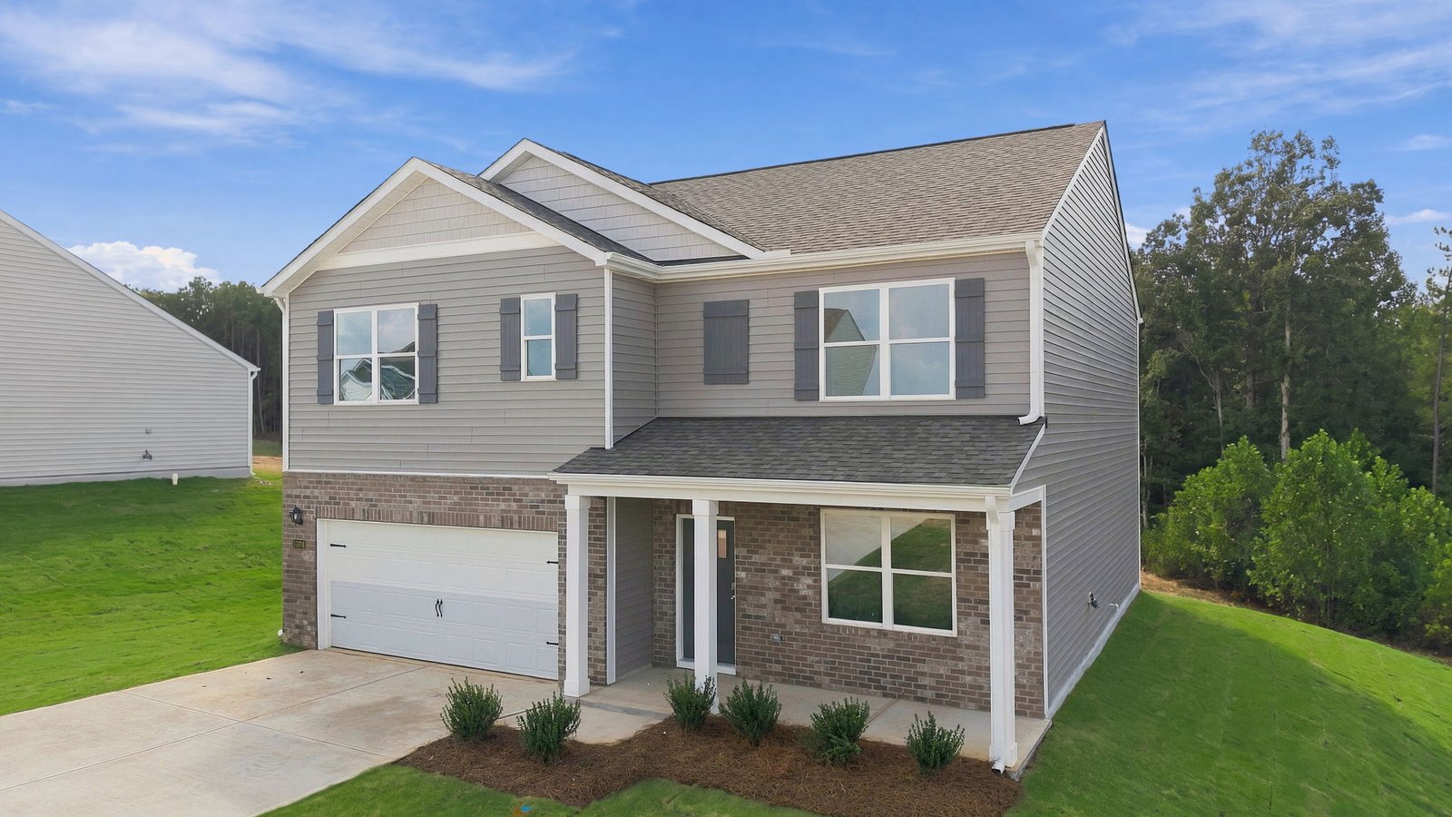 two story home with brick and vinyl and covered front porch