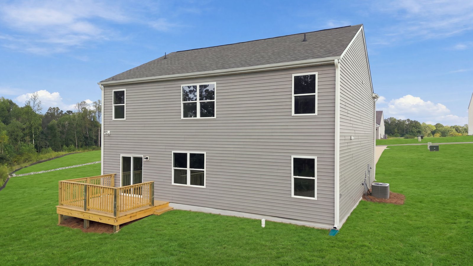 rear view of home and back lot with patio