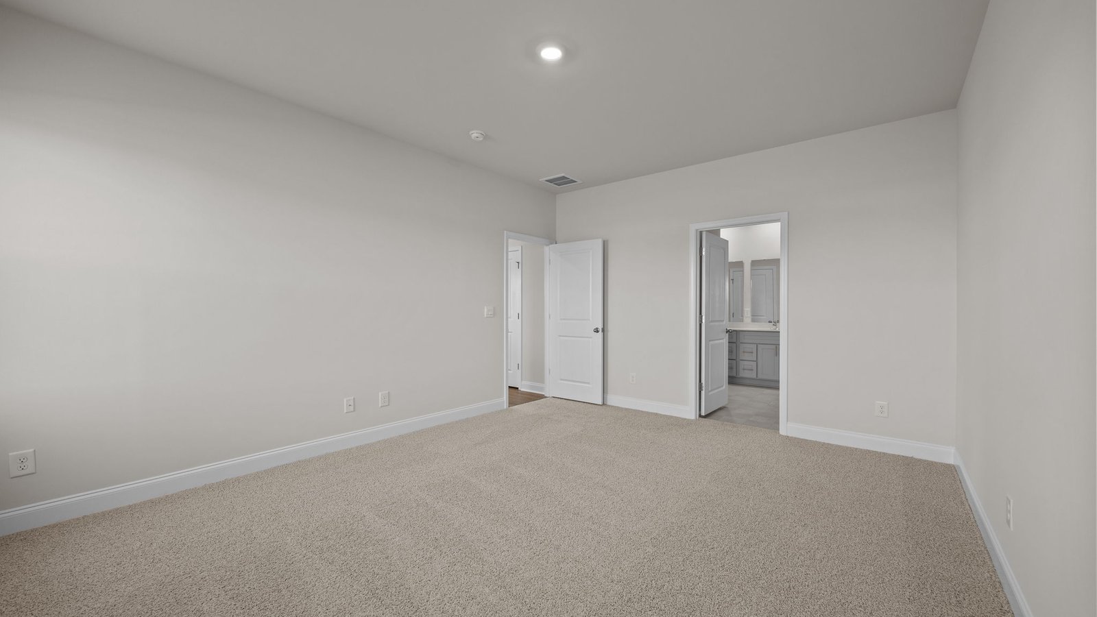 carpeted primary bedroom