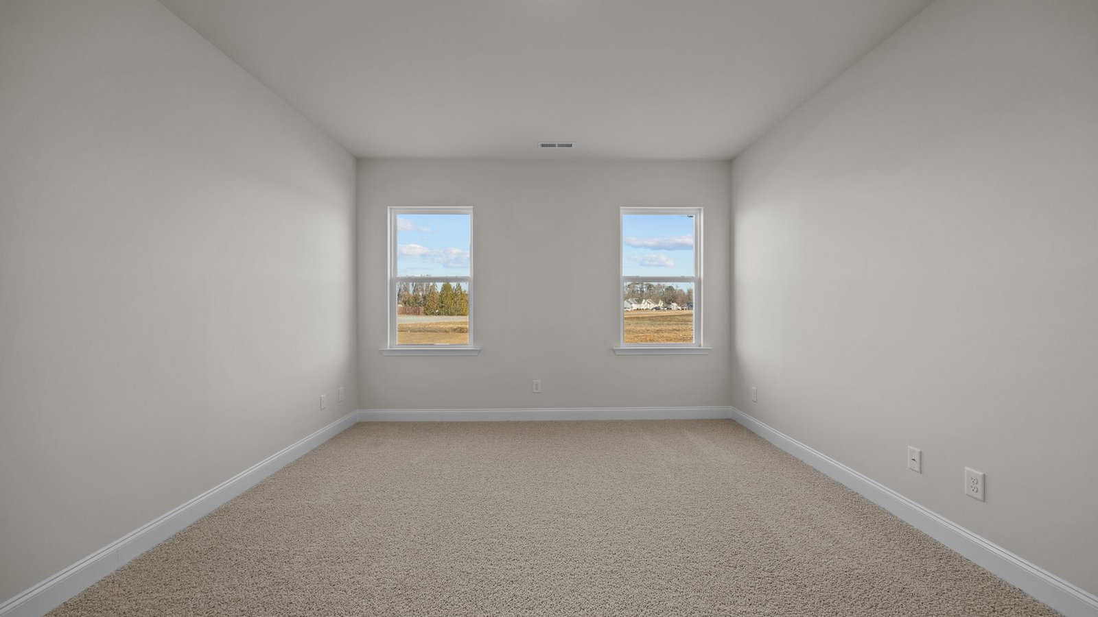 Primary bedroom with carpet flooring