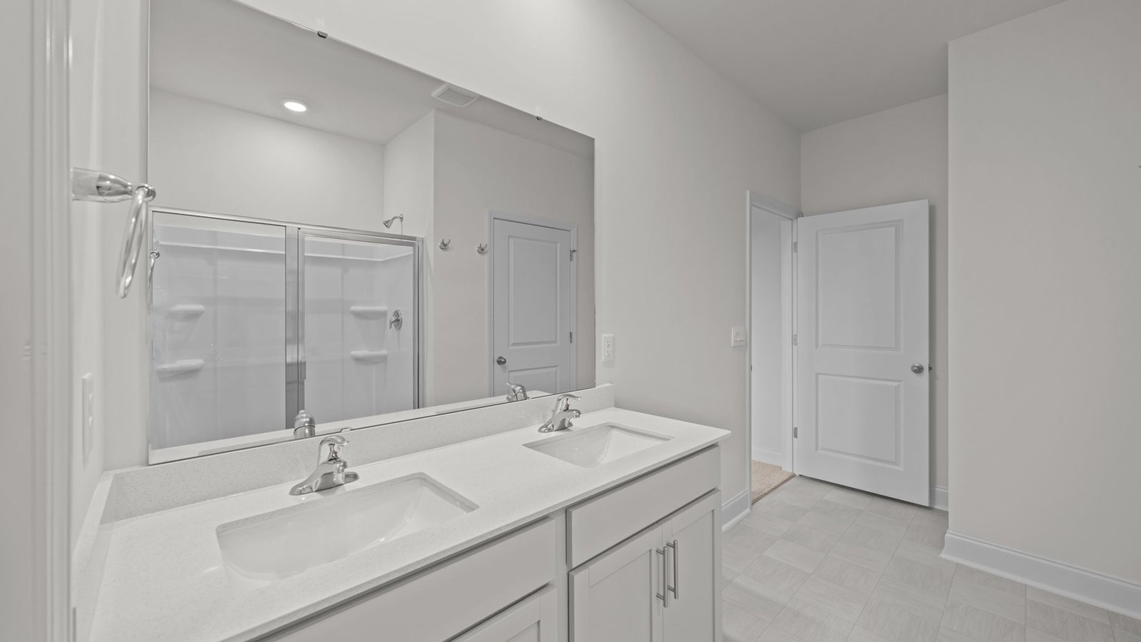 bathroom with double sinks and white cabinets