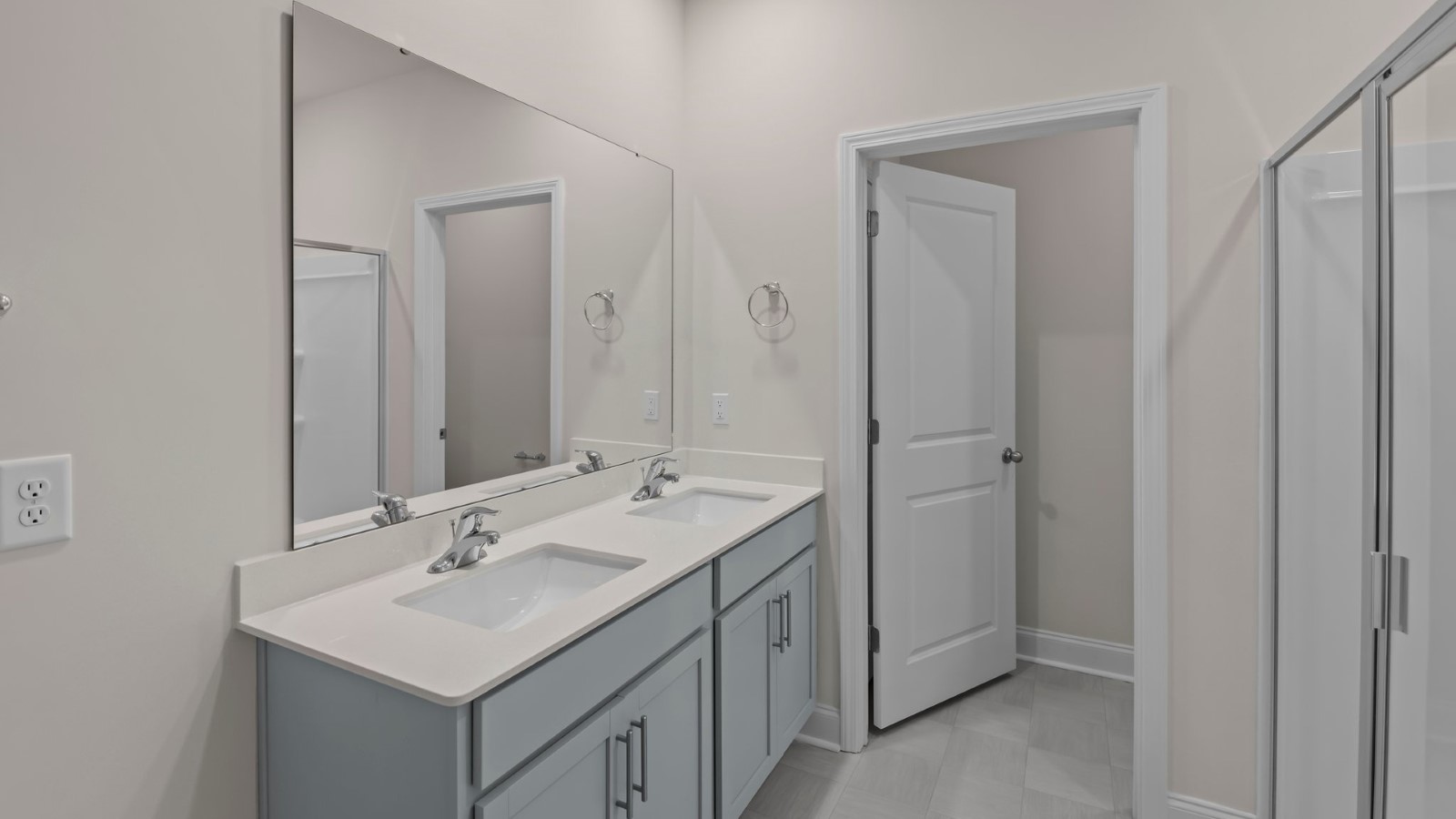 primary bathroom with double sinks and grey cabinets