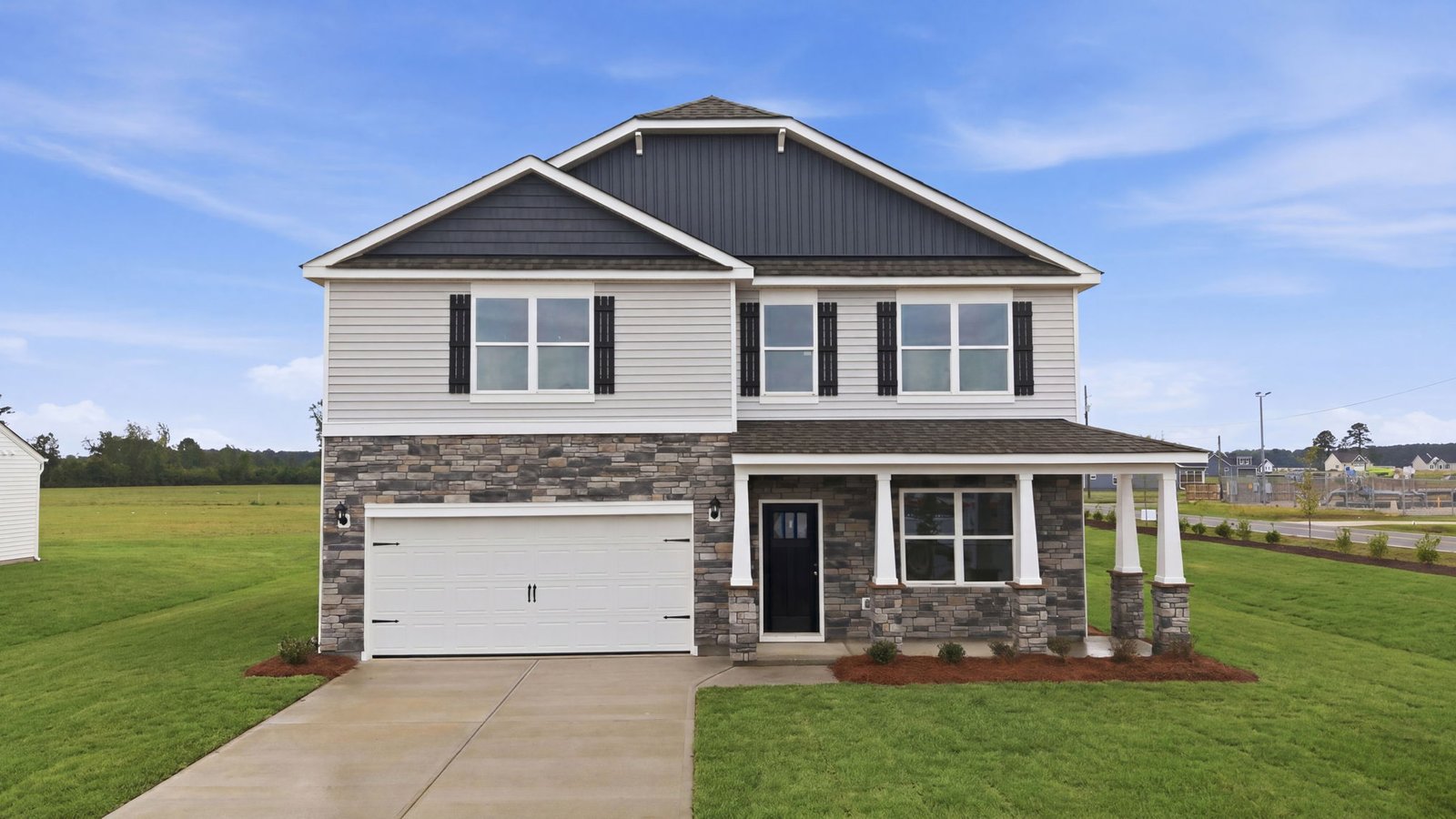 Front view of two story home with two car garage