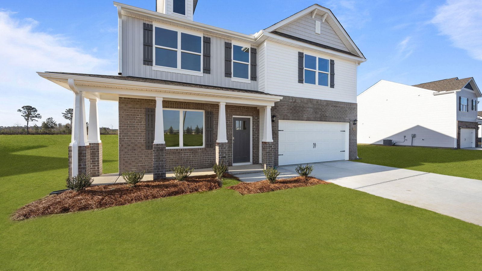 exterior of two-story home with covered front porch and two car garage