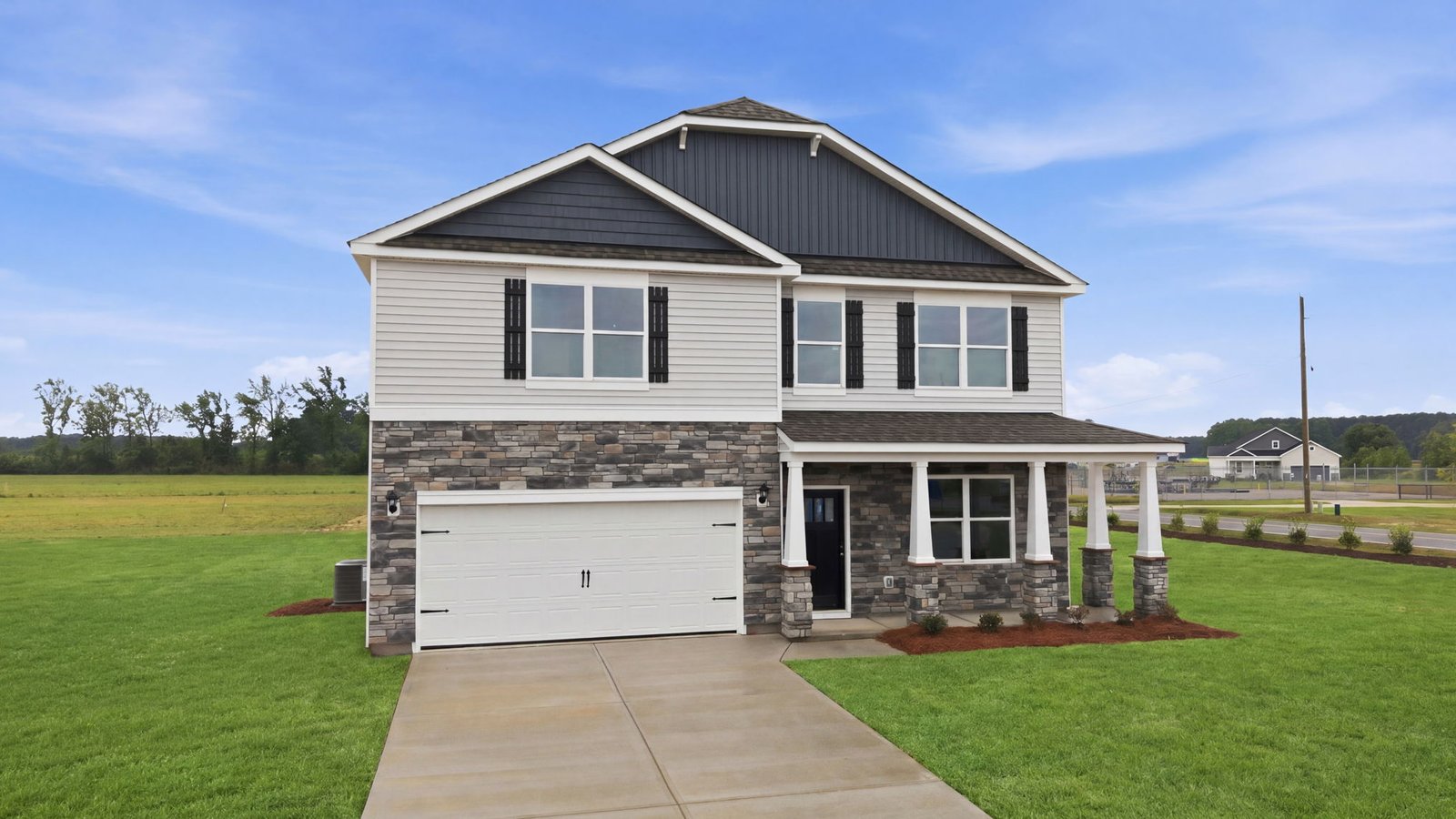 Front view of two story home with two car garage