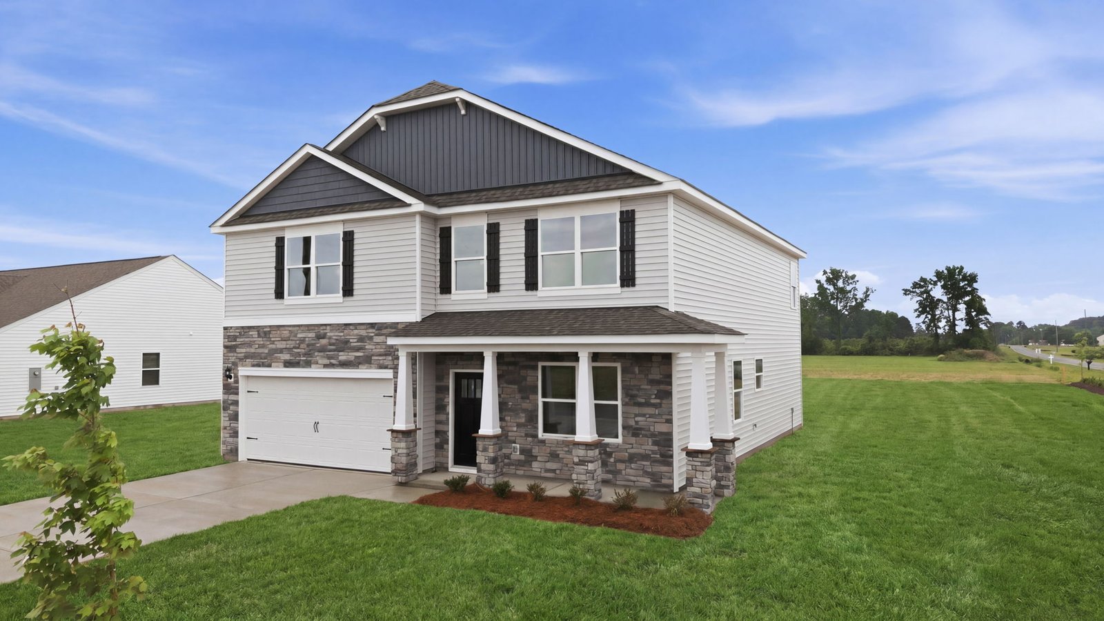 Front view of two story home with two car garage