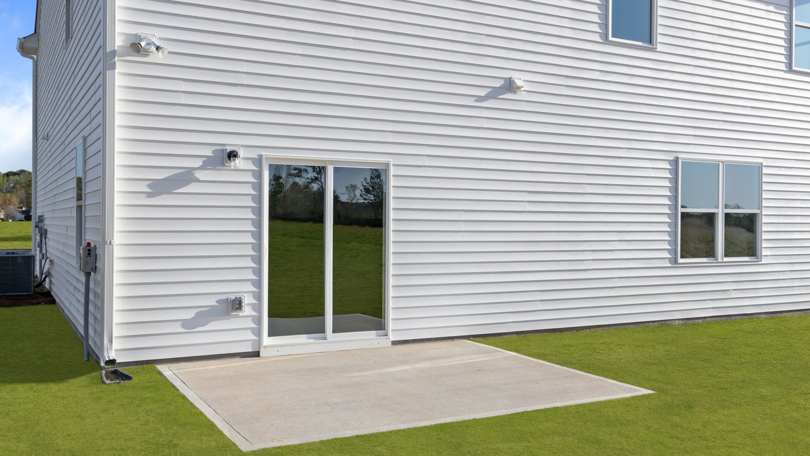 back of the two story home with back patio pad view