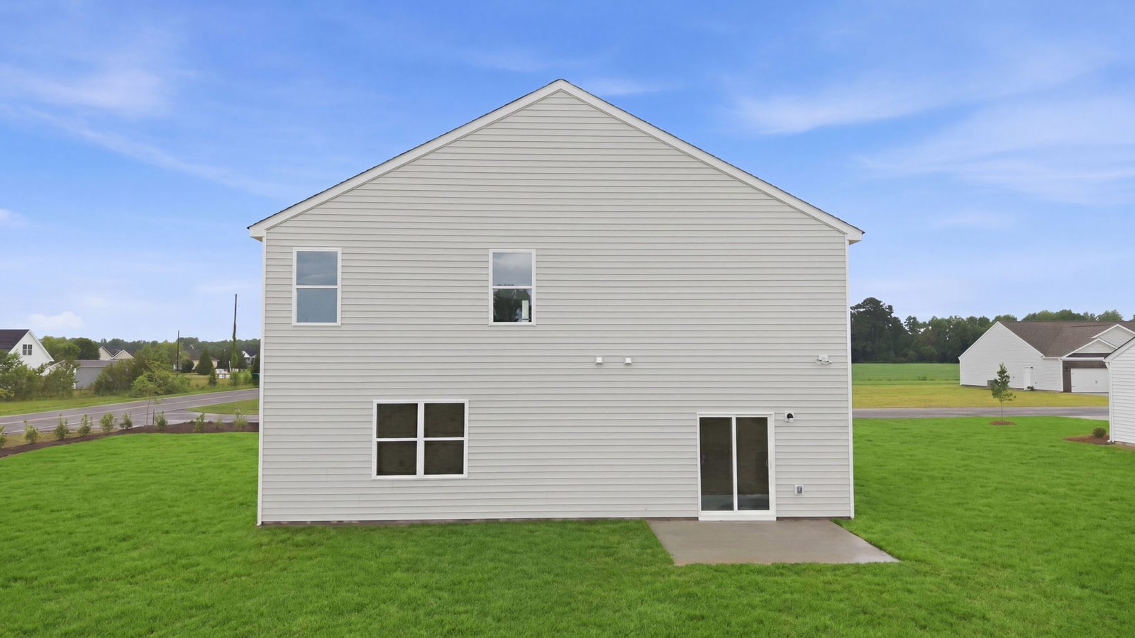 rear view of back of two story home and back yard