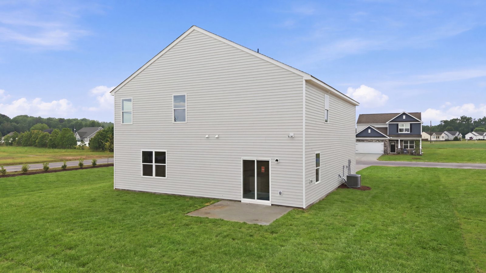 rear view of back of two story home and back yard