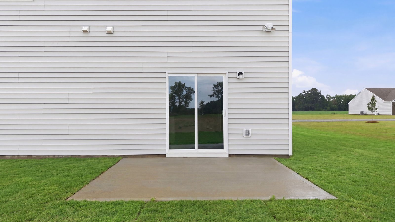 rear view of back of two story home and back yard