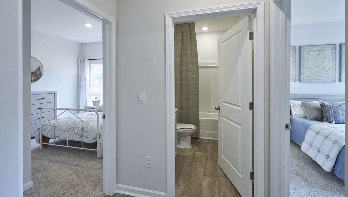 front entry way of home featuring brown flooring and white walls