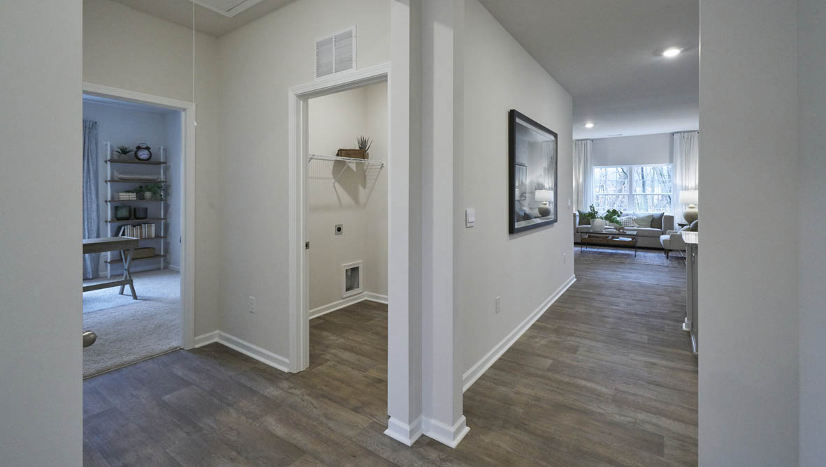 front entry way of home featuring brown flooring and white walls