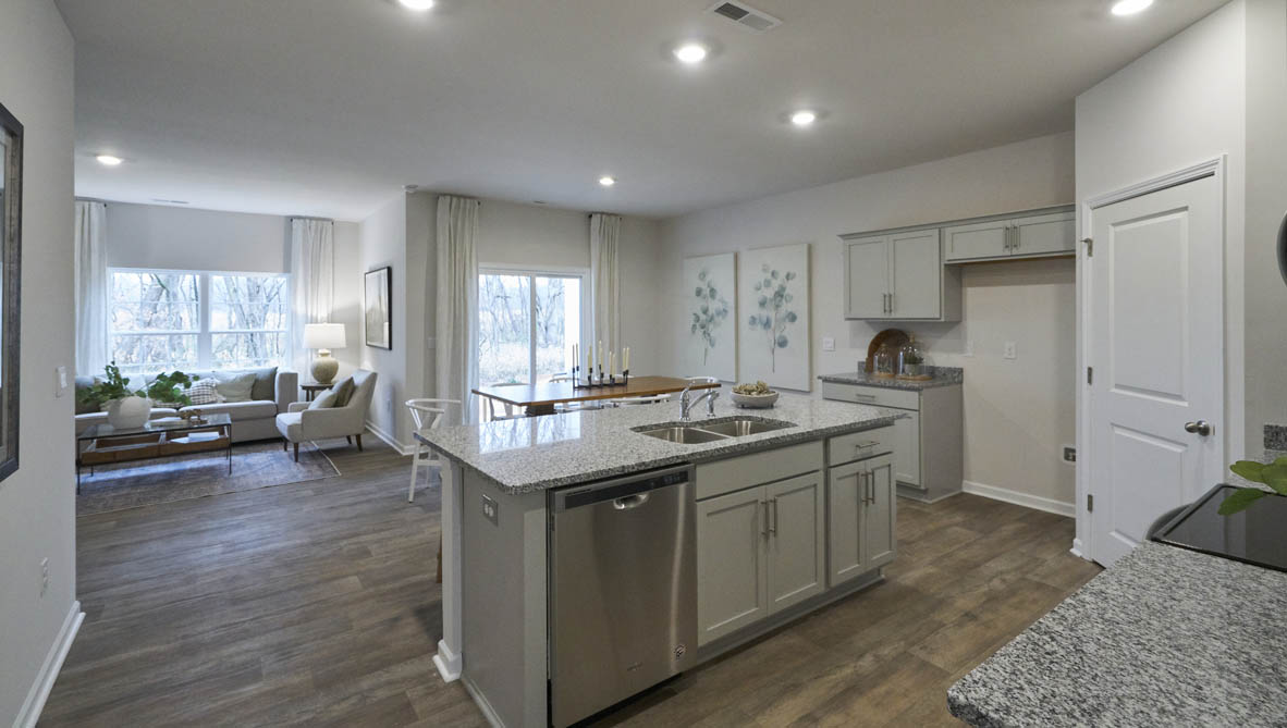 kitchen with light grey cabinetry, large island and stainless steel appliances