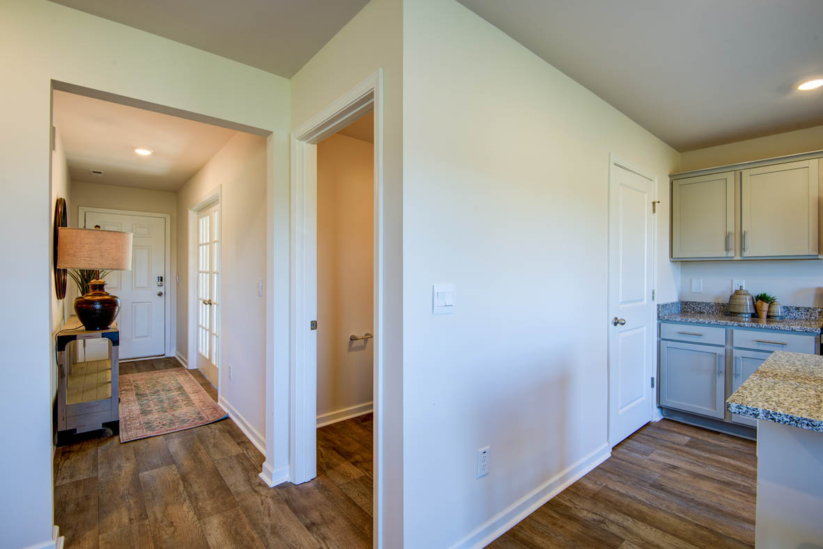 kitchen with light grey cabinetry, large island and stainless steel appliances