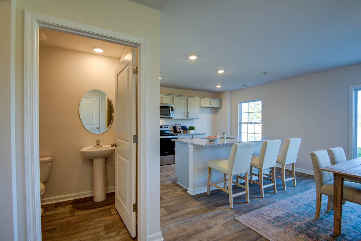 kitchen with light grey cabinetry, large island and stainless steel appliances