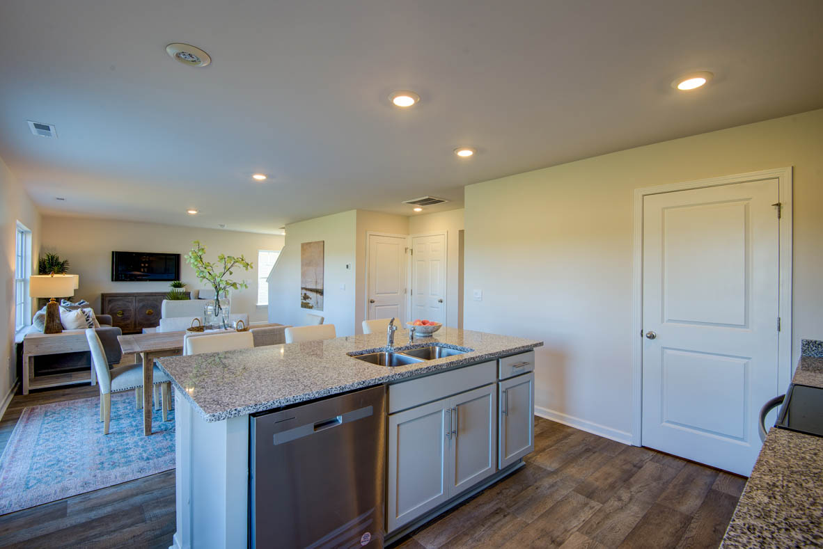 kitchen with light grey cabinetry, large island and stainless steel appliances