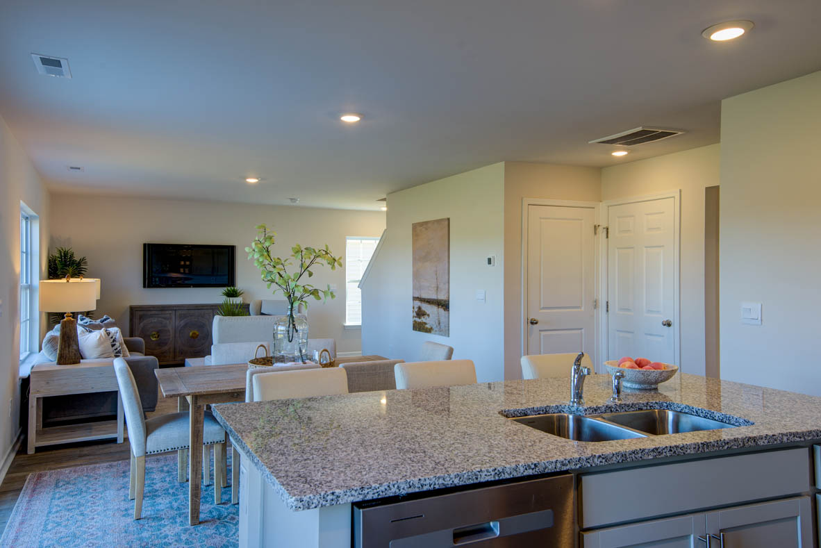 kitchen with light grey cabinetry, large island and stainless steel appliances