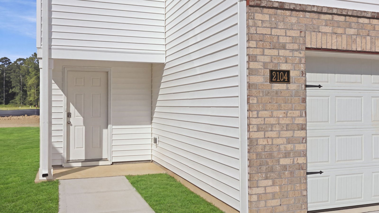 front view of home with garage view and sidewalk