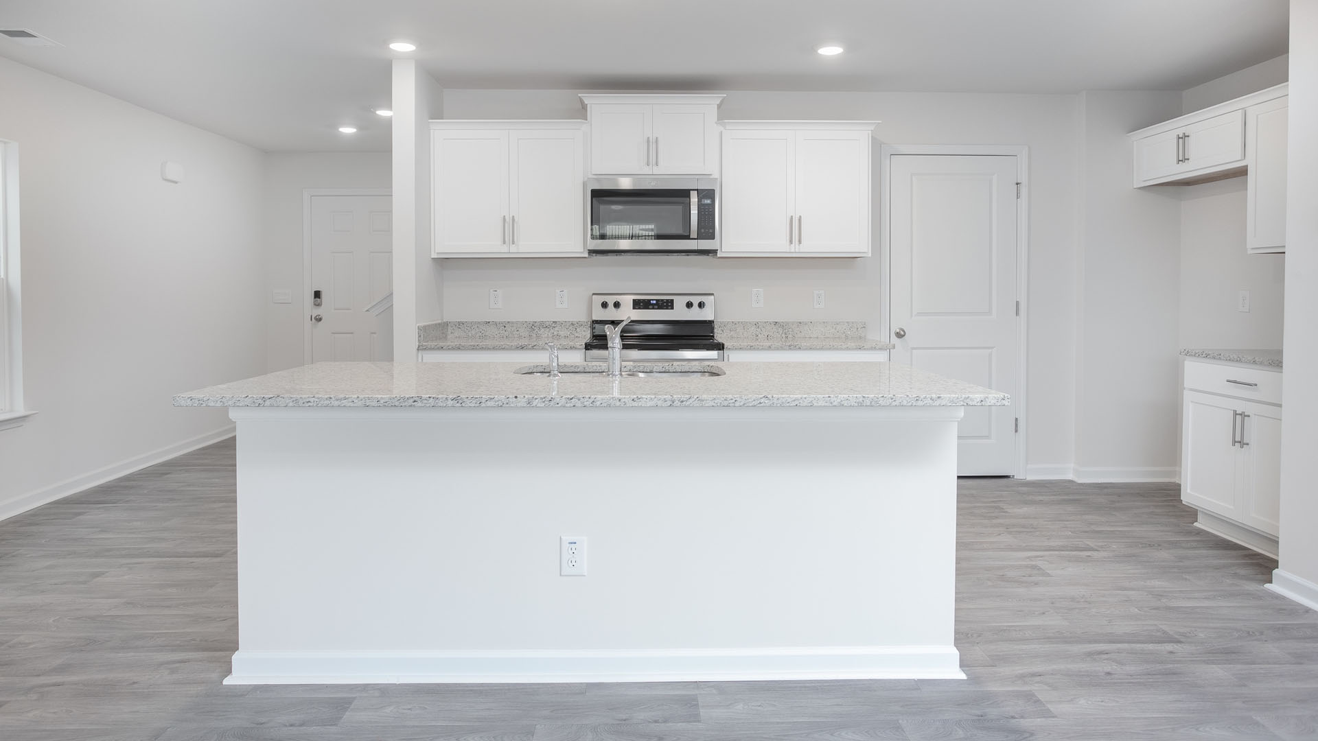kitchen view with island and white cabinets