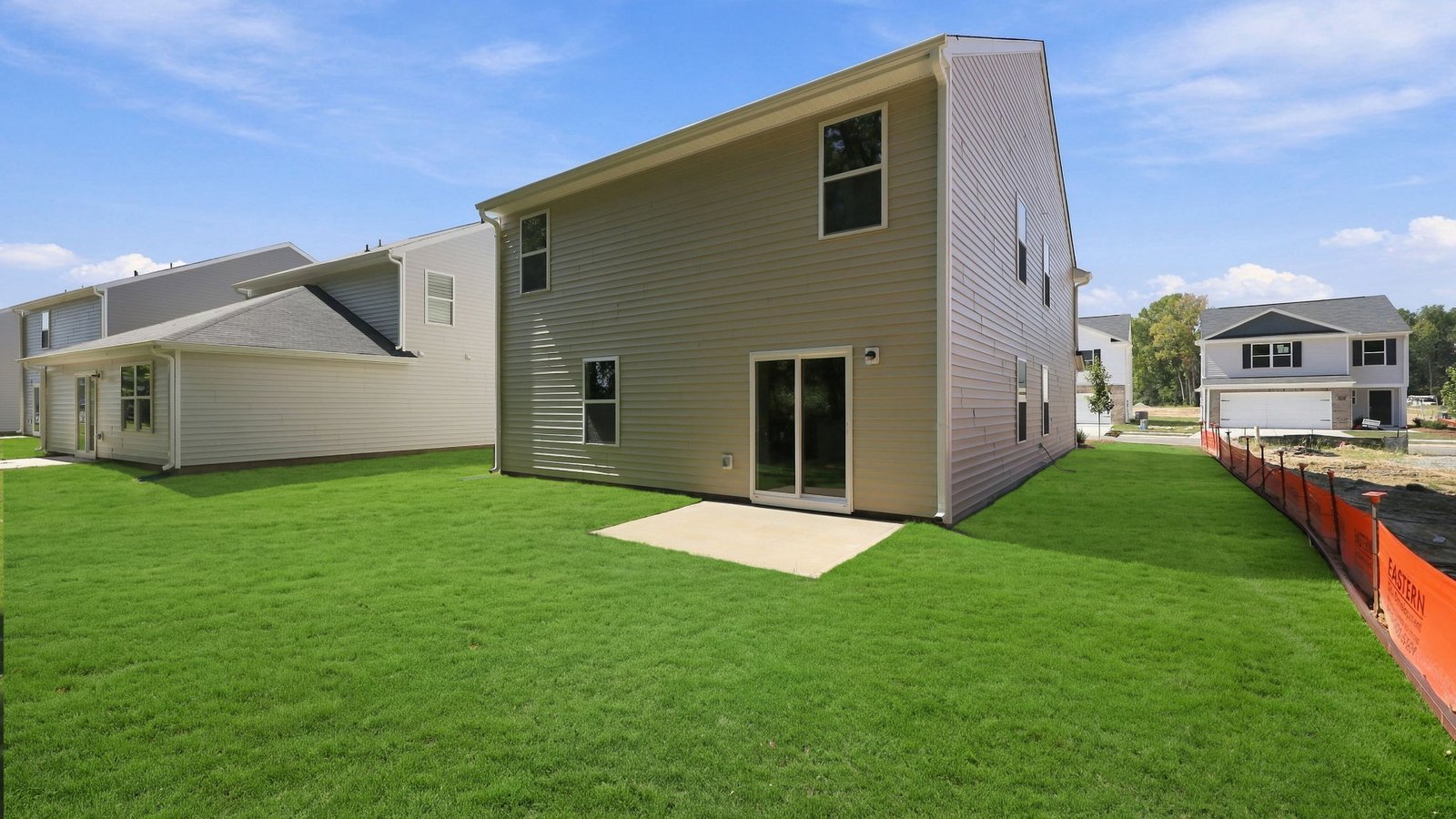 rear view of the home and back yard and lot