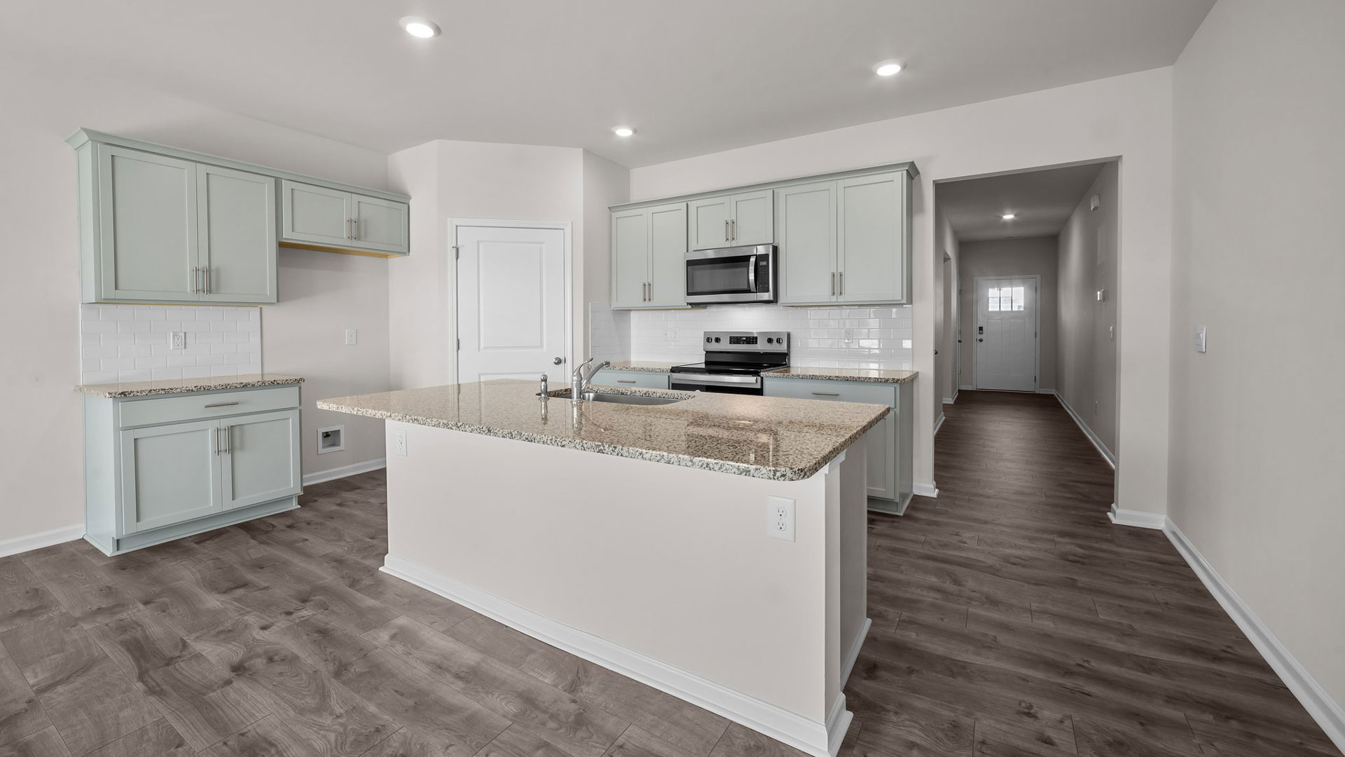 kitchen area with island and stainless steel appliances