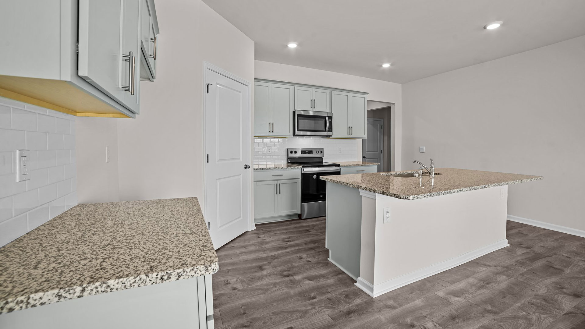 kitchen area with island and stainless steel appliances