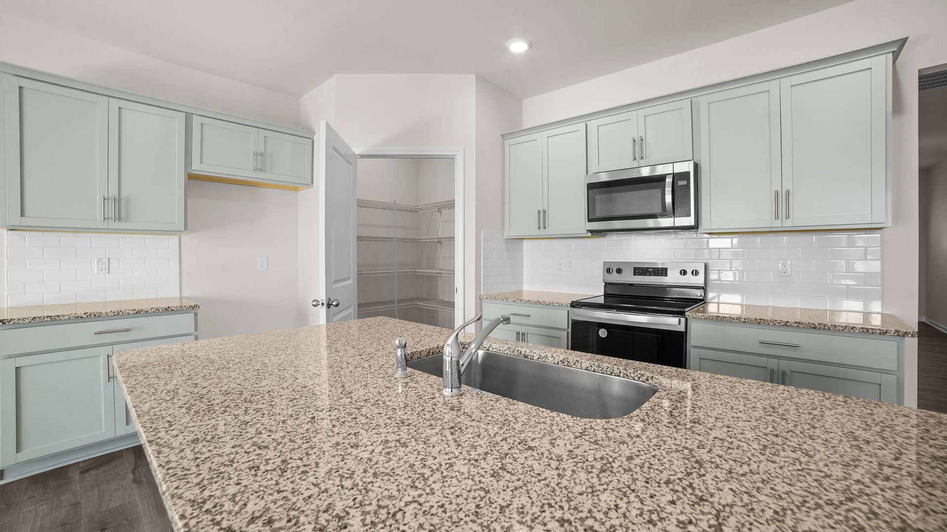kitchen area with island and stainless steel appliances