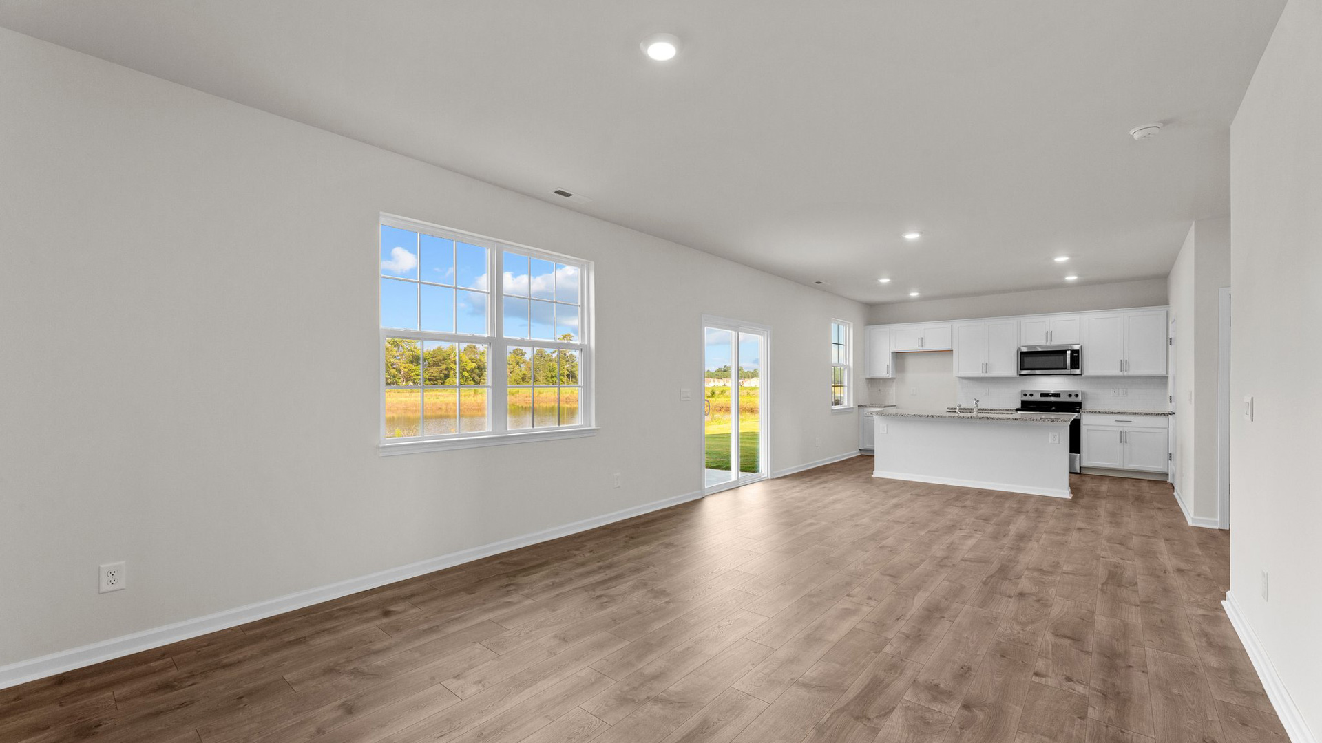 Open-concept living room with revwood flooring