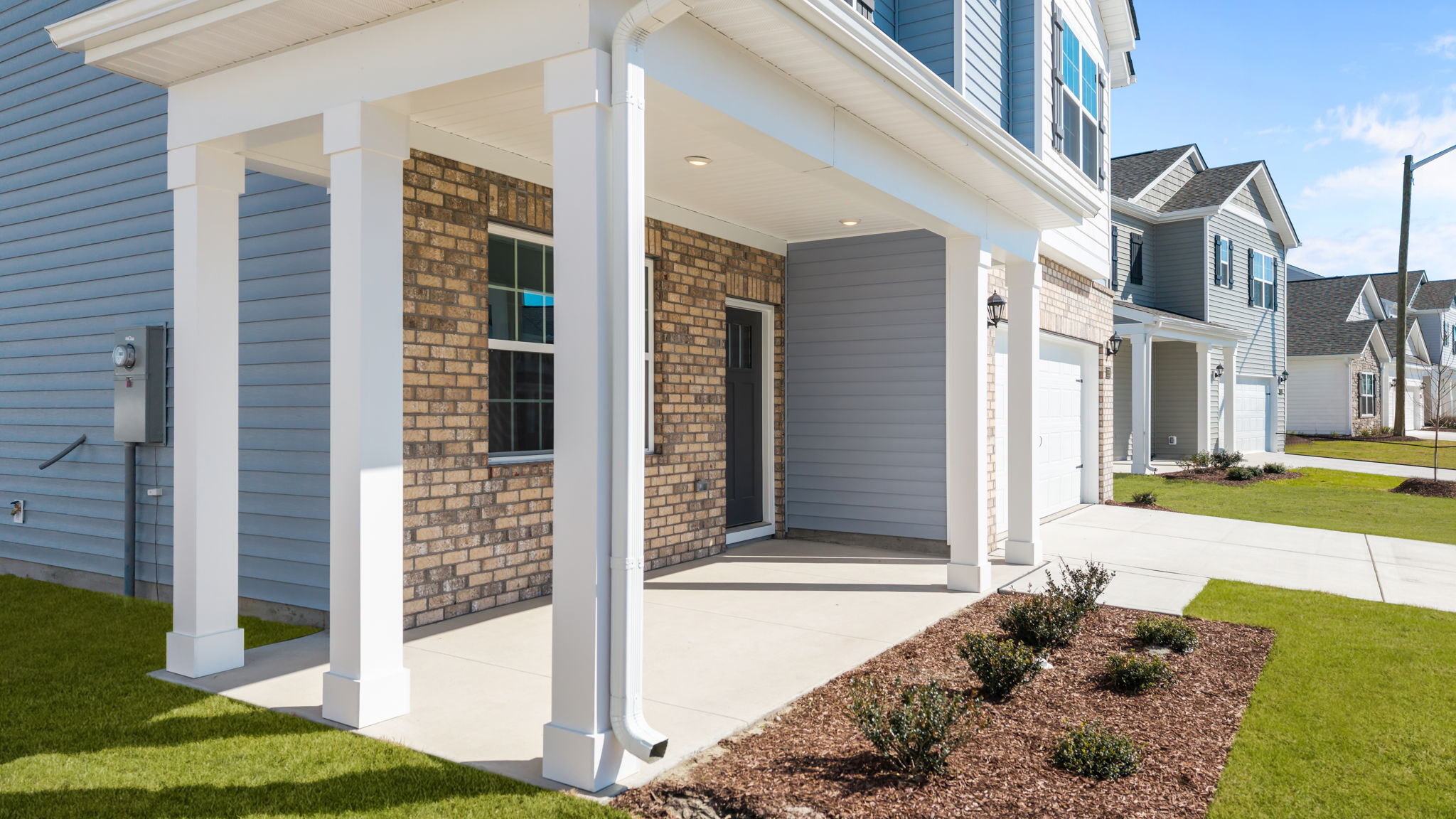 Covered front porch and brick by the front door