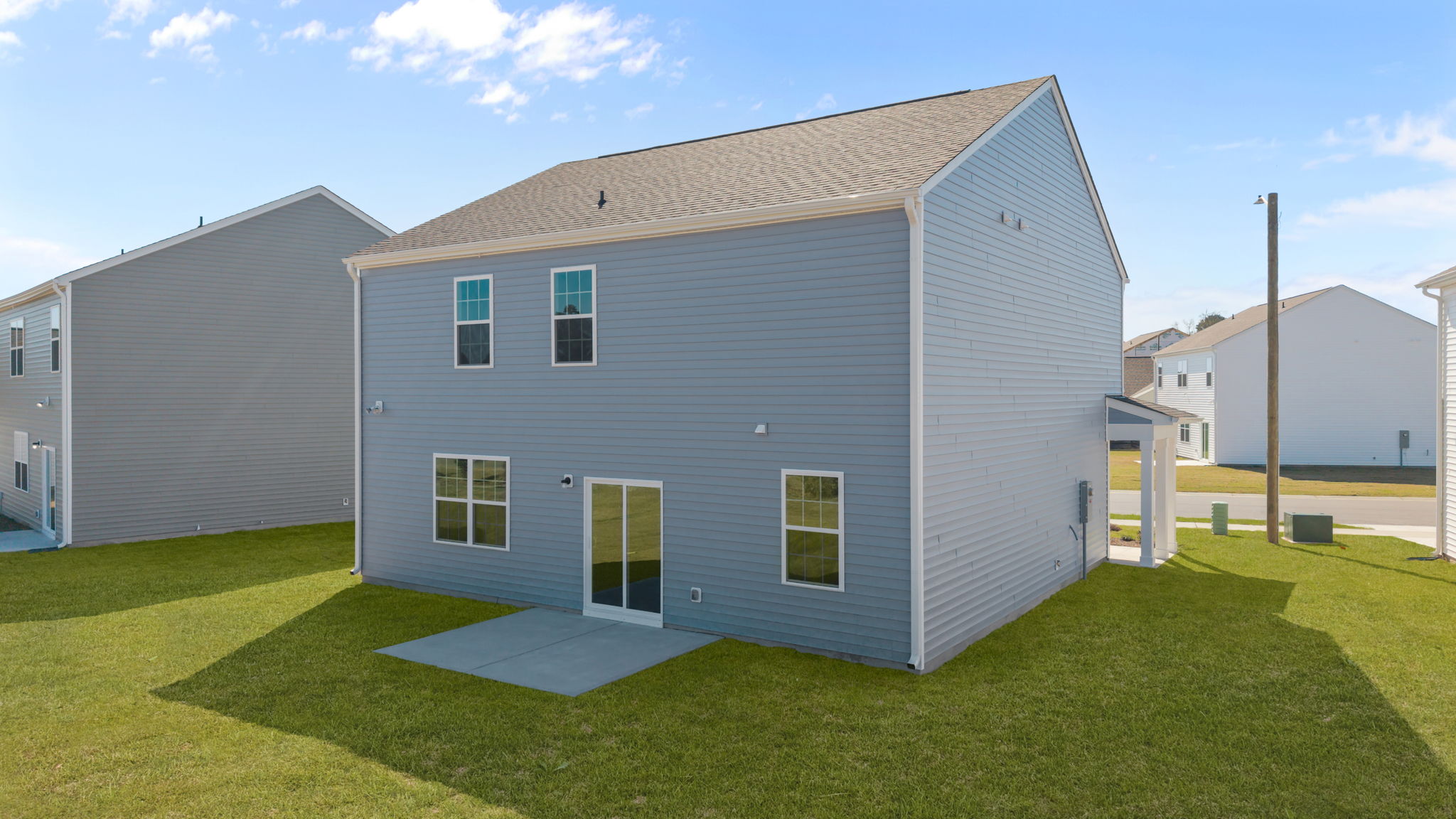 Rear view of the two story home from the back yard