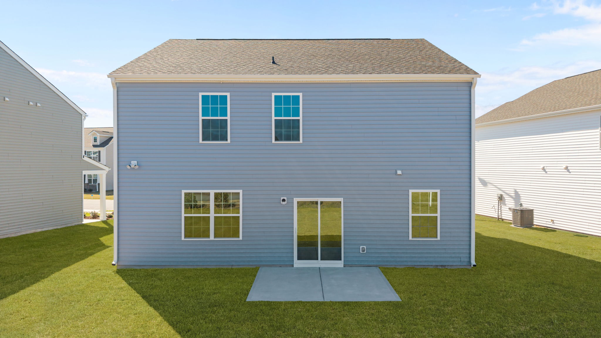 Rear view from the back of the home featuring sliding glass door from kitchen area