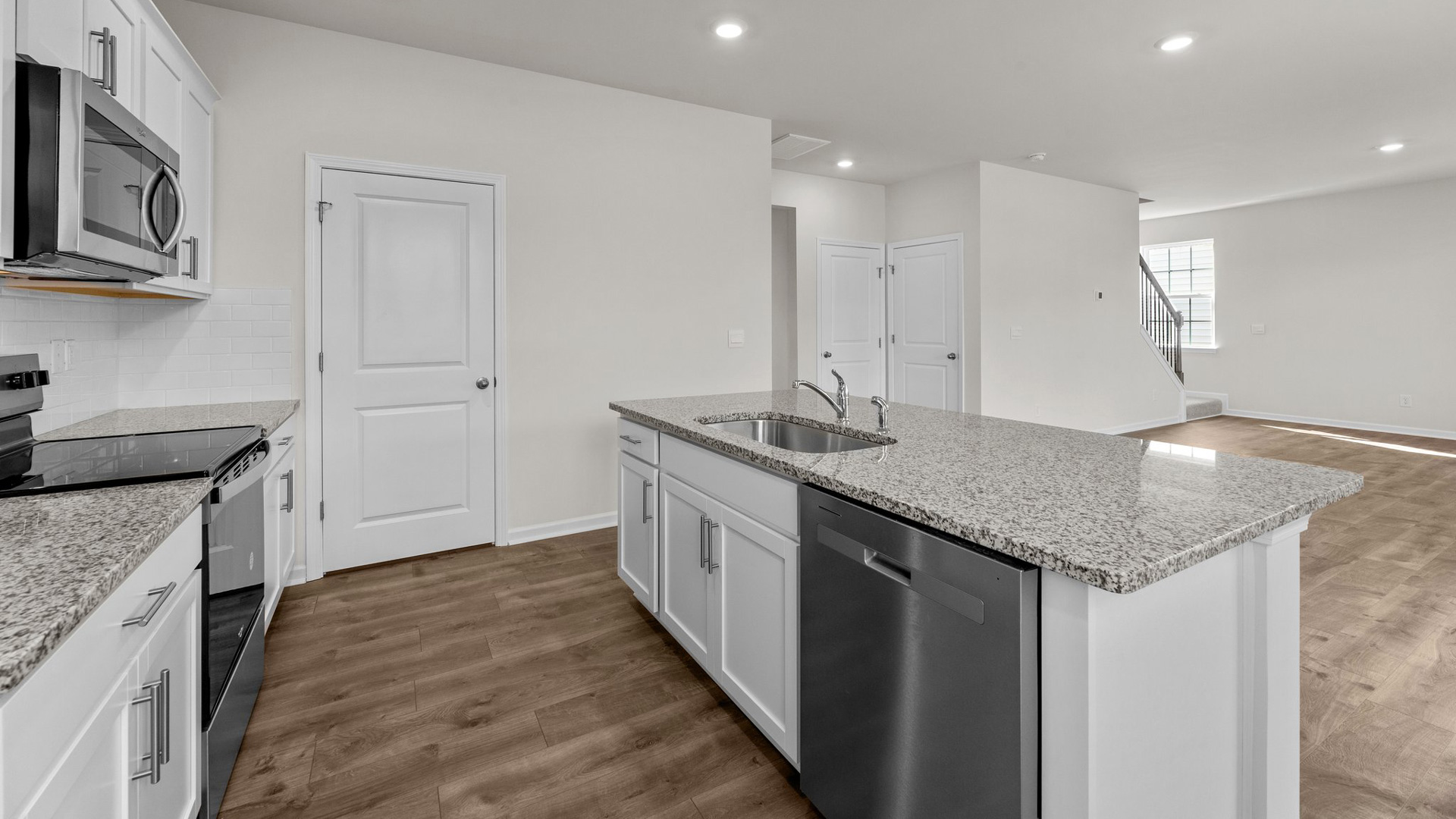 kitchen with white cabinetry, large island, and stainless steel appliances