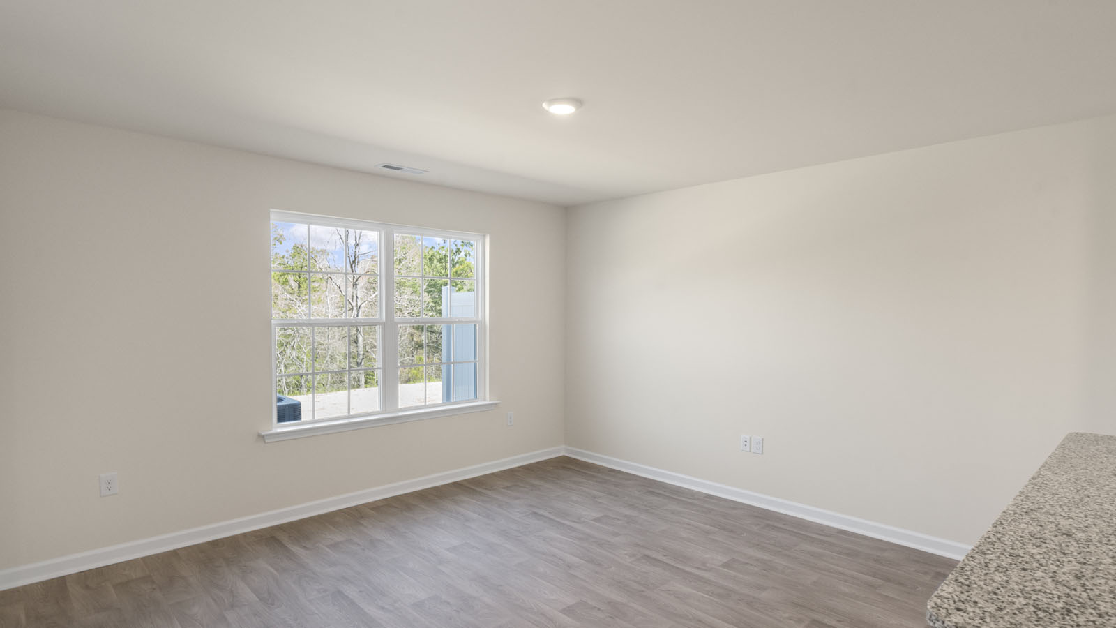 bedroom with beige carpet, beige walls and a window