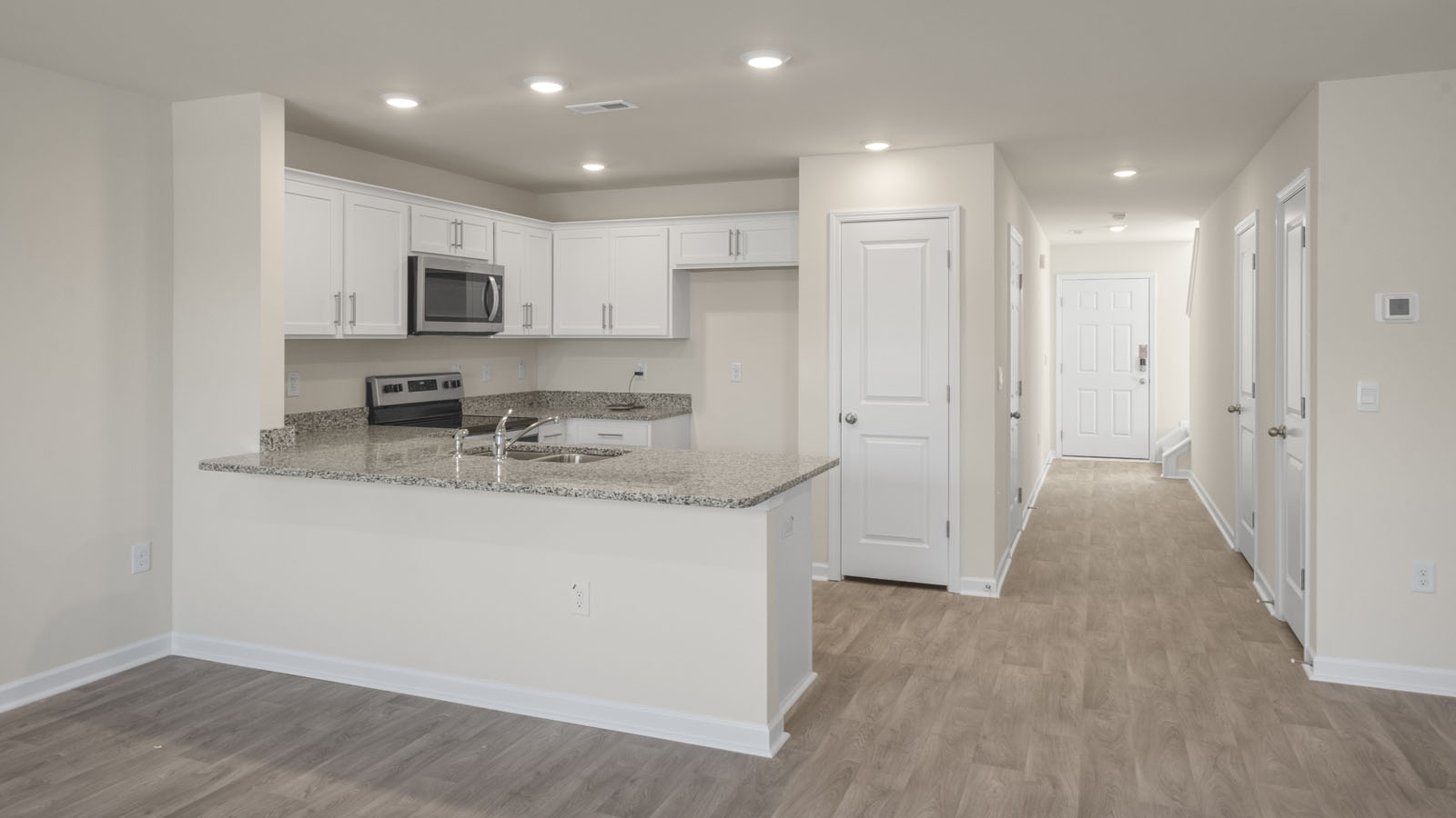 kitchen with white cabinetry, large island, and stainless steel appliances