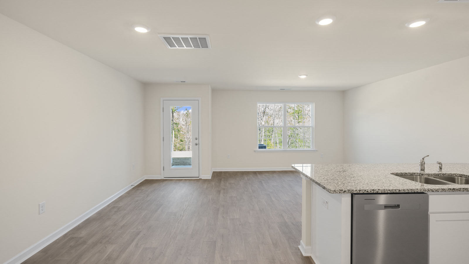 Open concept first floor with the living room, dining room and kitchen next to each other