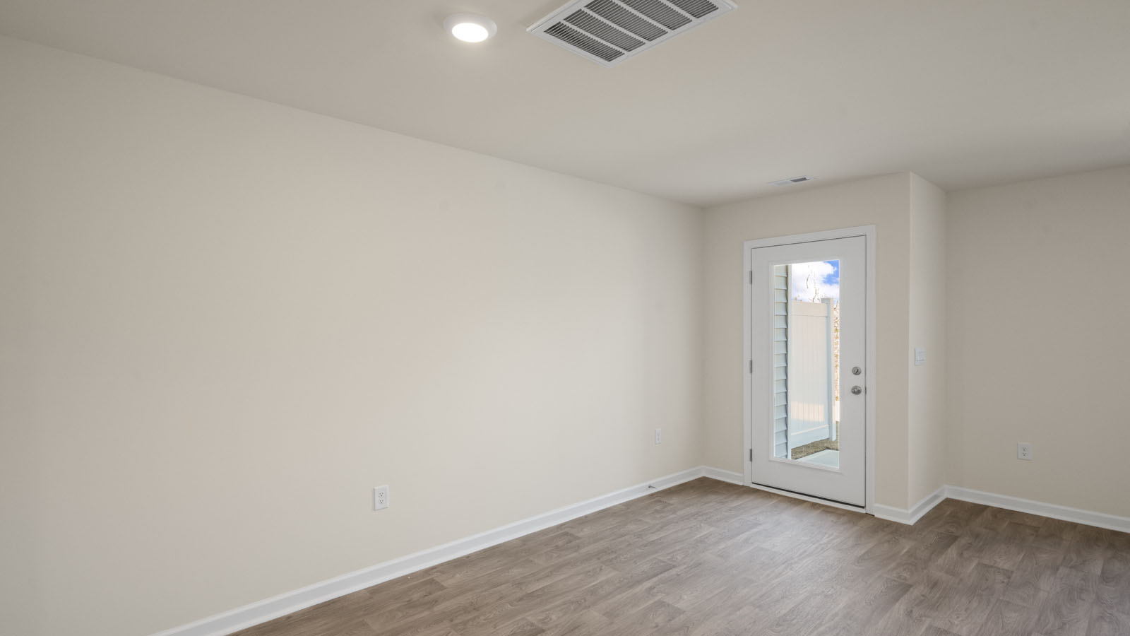 bedroom with beige carpet, beige walls and a window