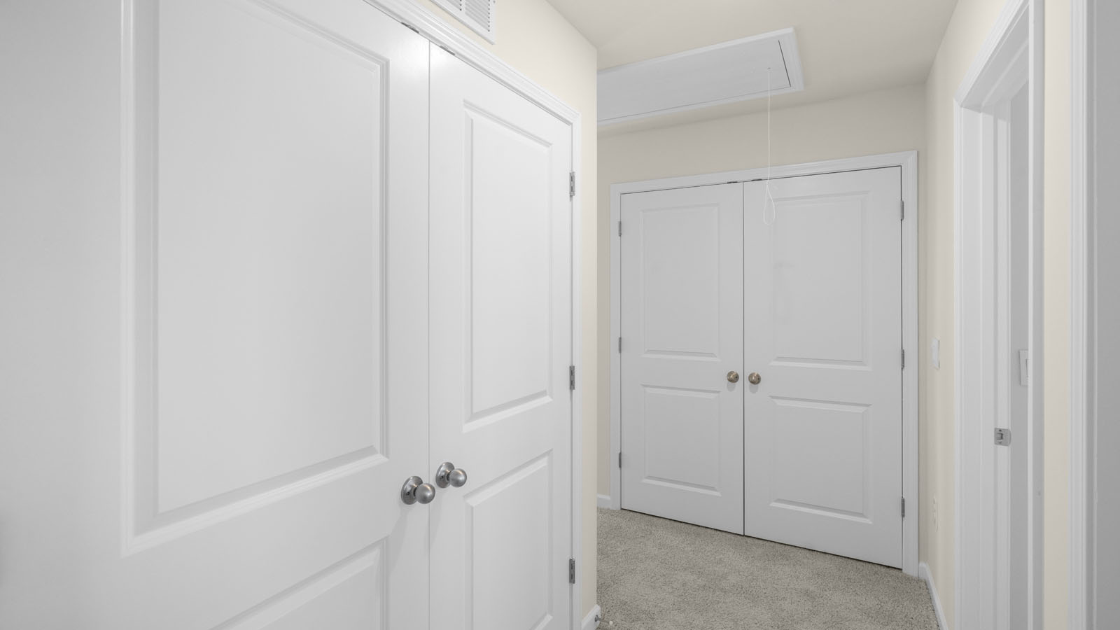 bedroom with beige carpet, beige walls and a window
