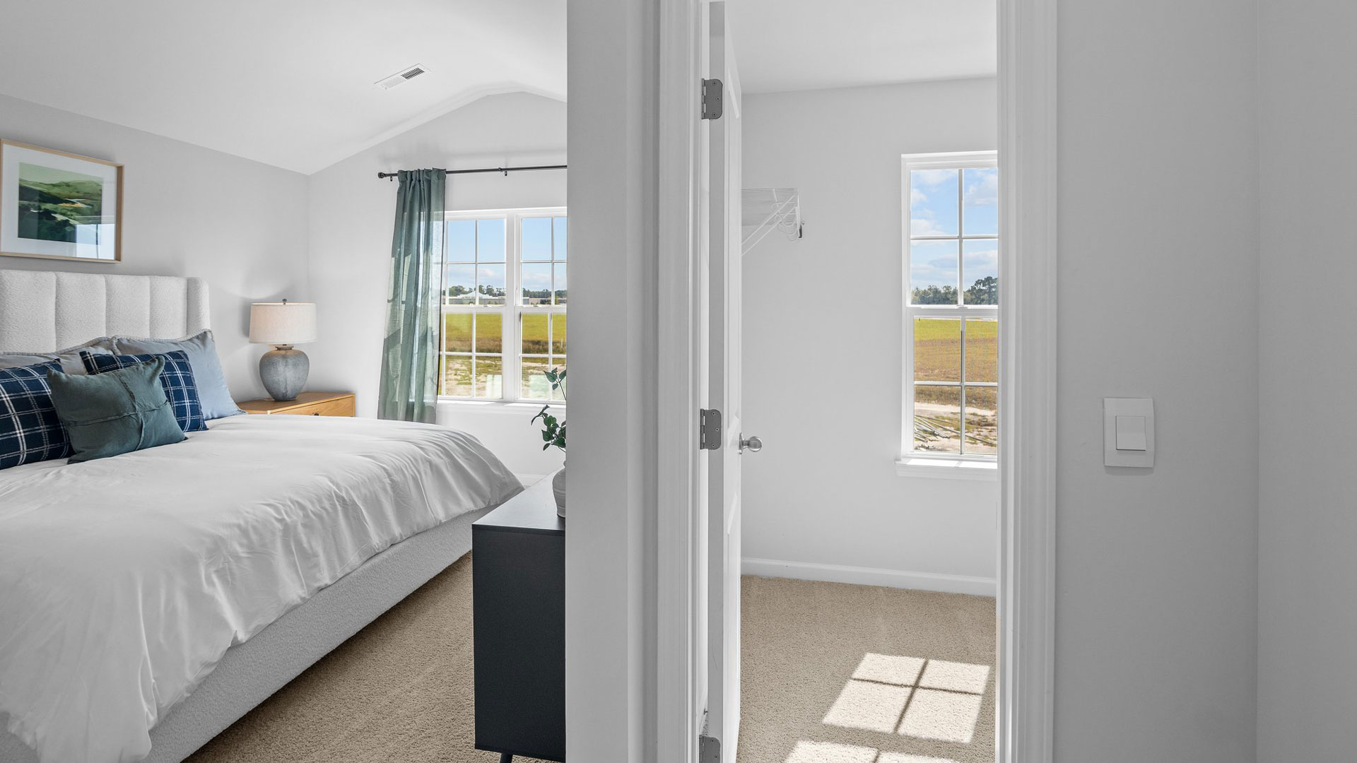 Bedroom with carpet flooring and walk-in closet