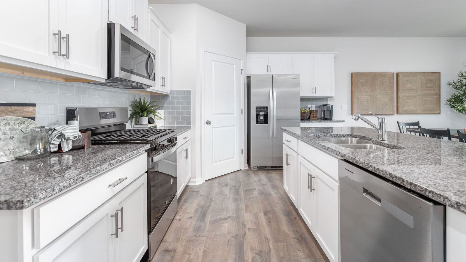 kitchen with white cabinetry, large island, and stainless steel appliances