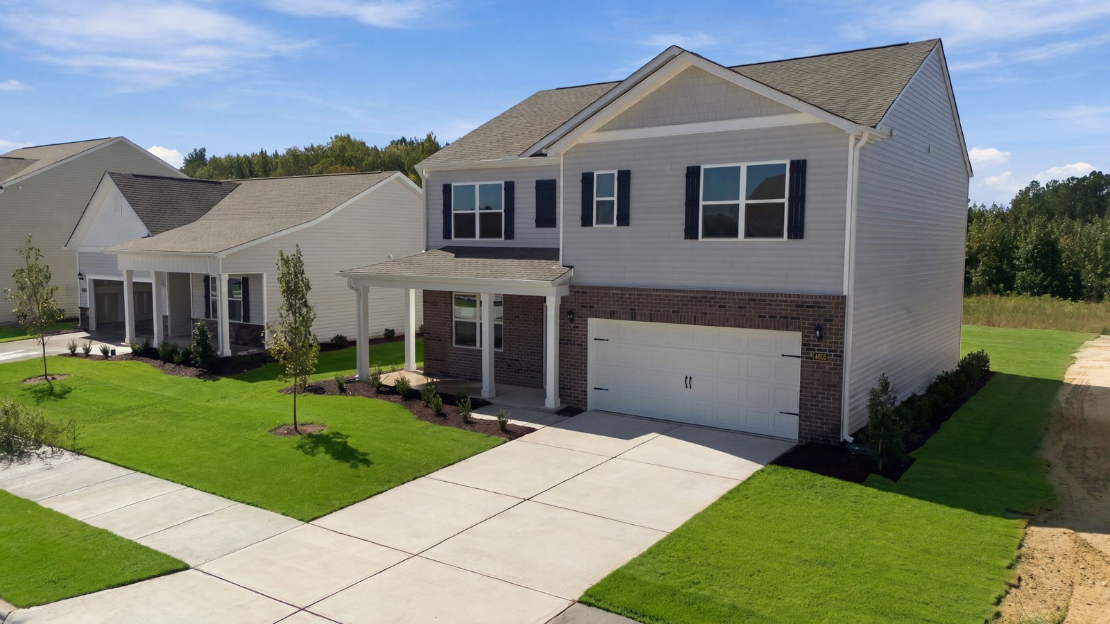 front view of two story family home with two car garage