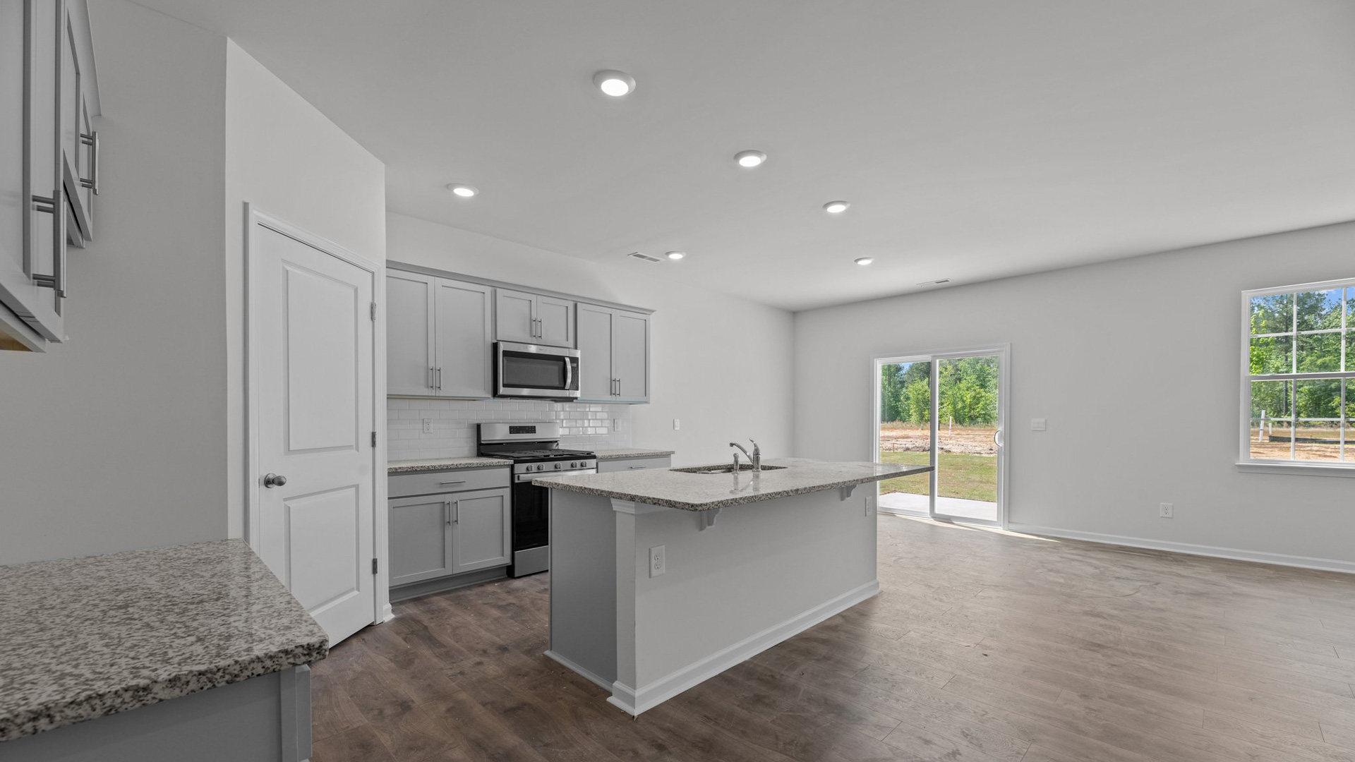 open concept layout kitchen with stainless steel appliances