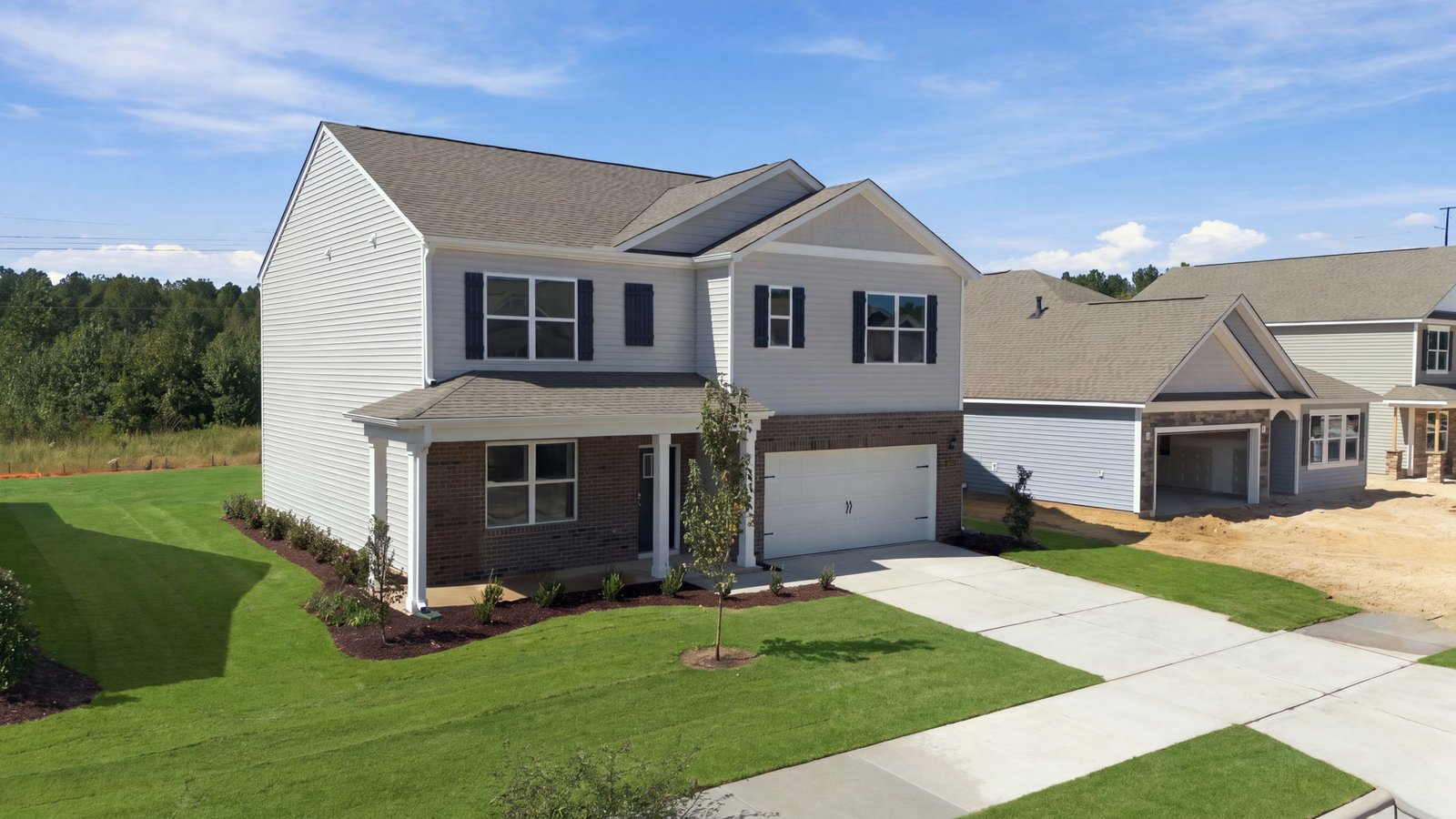 front view of two story family home with two car garage