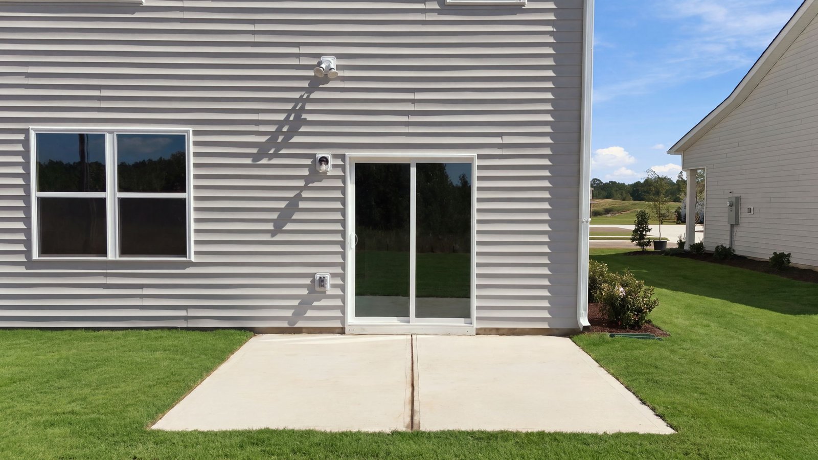 rear view of the home and back patio pad