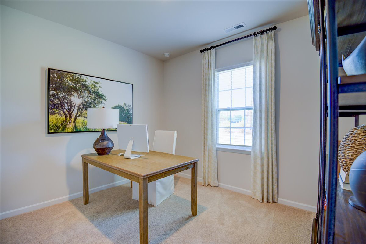 bedroom with beige carpet, beige walls and a window