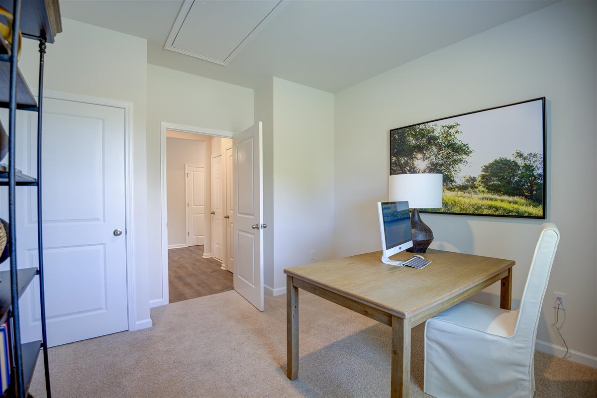 bedroom with beige carpet, beige walls and a window